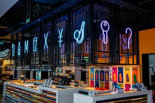 a store with neon signs on the wall at Moxy Ningbo Old Bund in Ningbo