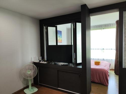 a bedroom with a mirror and a dresser with a bed at 4 Floor - Centrio Condominium in Phuket town in Phuket