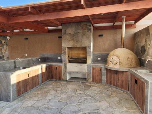 a large kitchen with a large stone oven in it at Casa de campo de estreno en Cieneguilla, Lima-Perú in Cieneguilla