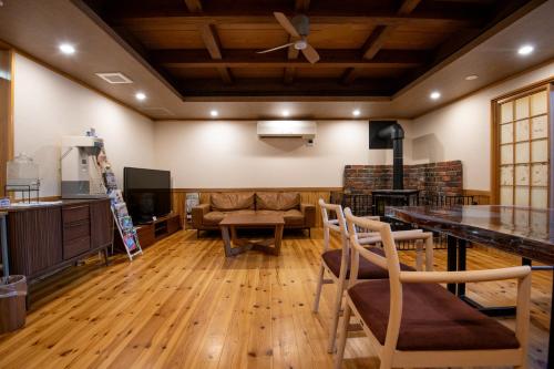 a living room with a couch and a table at Tsukasa Ryokan in Saga