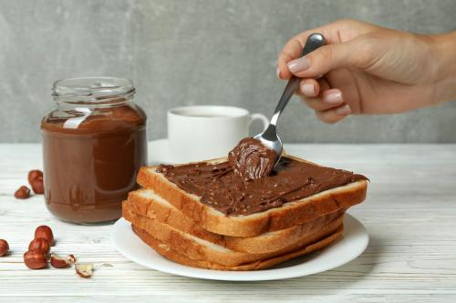 a person eating a piece of chocolate cake with a fork at @House of Belva Pleret Balong Waterpark in Gondowulung