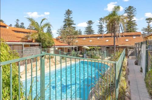 a swimming pool with a fence around it at 13 Cottesloe - steps from beach - sleeps 3 in Perth