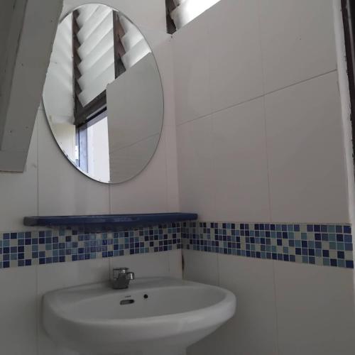 a bathroom with a sink and a mirror at Sleep at home hostel in Bangkok