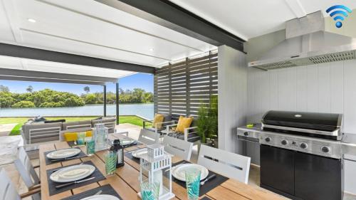 a kitchen and dining room with a view of the water at Watersedge in Currarong