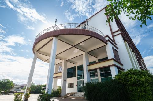 a building with a round balcony on top of it at River Hotel - The Outstanding Venues Nakhon Pathom in Ban Hua Na Pa