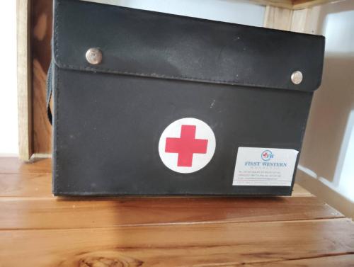 a black wallet with a red cross on it at Koh Phaluai beach cottage in Koh Phaluai
