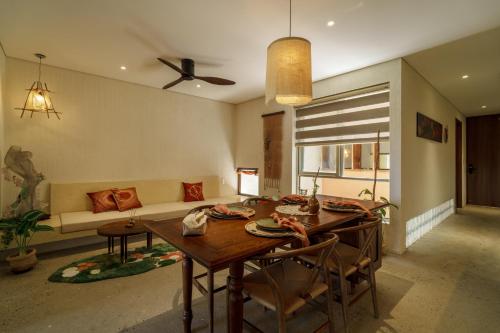 a living room with a table and a couch at Camfusion House in Hoi An