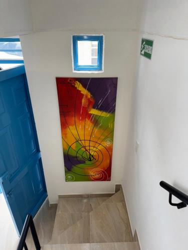 a colorful painting on the wall of a room at Casa Villa Paz Salento in Salento
