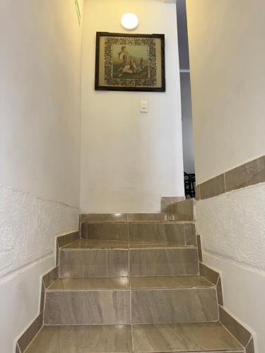 a set of stairs with a picture on the wall at Casa Villa Paz Salento in Salento
