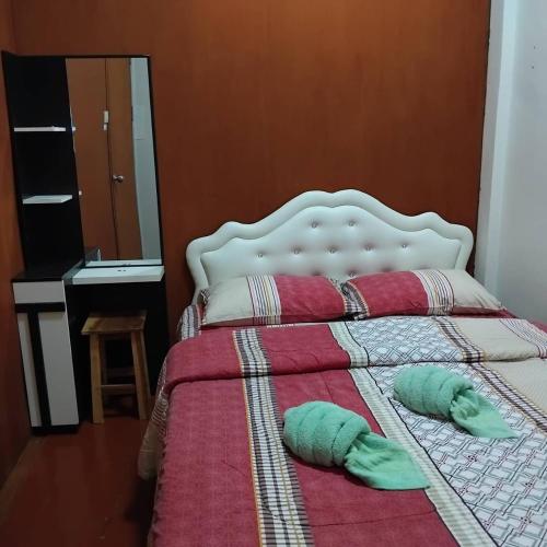 a bedroom with a bed with two pillows on it at Sleep at home hostel in Bangkok
