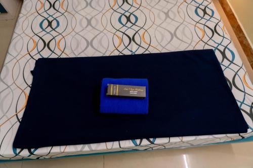 a black laptop with a blue box on a table at Sree Theja Residency in Anantapur