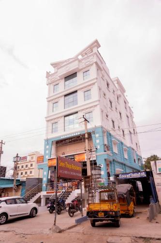 a yellow truck parked in front of a building at Sree Theja Residency in Anantapur
