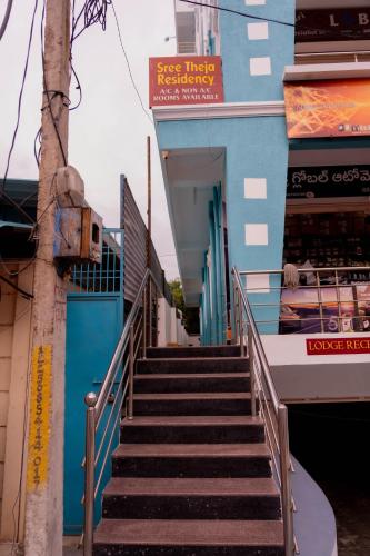 a stairway leading up to a blue building at Sree Theja Residency in Anantapur
