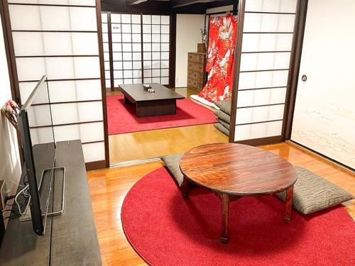 a room with a table and a room with red carpet at Tanabe no Yado Ataigawa - Vacation STAY 10883v in Tanabe