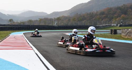 three people riding down a race track on antrack at Belle Fore Resort in Jeungpyeong