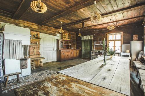a large living room with a large wooden table at Pagulbis - Tavo namai in Klabiniai