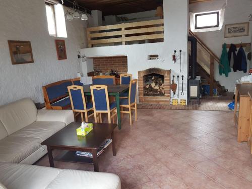 a living room with a couch and a table and a fireplace at Chalupa u Otavy Horní Poříčí in Horní Poříčí