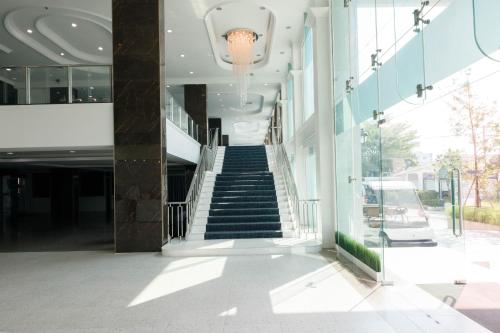 a stairway leading up to a building with a staircase at River Hotel - The Outstanding Venues Nakhon Pathom in Ban Hua Na Pa