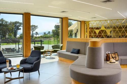 a living room with a couch and chairs at Kinar Galilee in Kinar