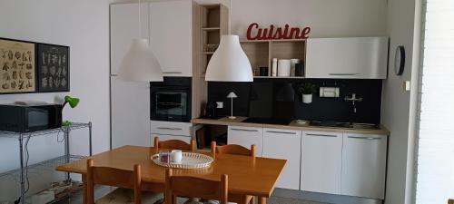 a kitchen with a table and a dining room at Il nido in Marina di Massa