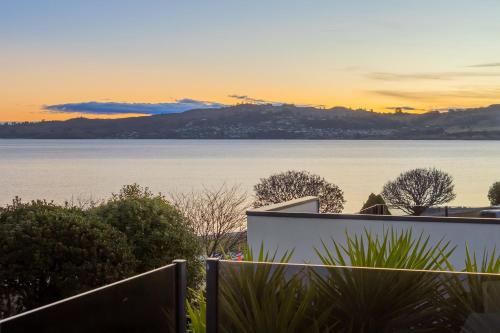 a view of the water from a house at Gather Taupo - Lakeview - Spa Pool in Taupo