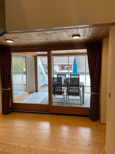 a room with a sliding glass door with a table and chairs at Gasthaus Rössle in Nenzing