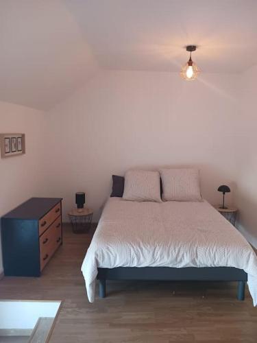 une chambre avec un grand lit et une commode dans l'établissement Maison d'Elodie, à Joserand