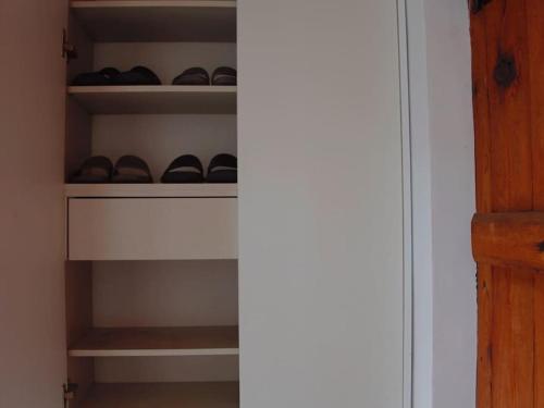 a closet with a bunch of shoes on shelves at Cheongryang-Anchae 2BR 2BA Hanok Spa Free Parking in Seoul
