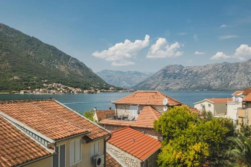 a view of a town with mountains and water at Lux Seaside Residence in Kotor