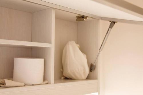 a shelf with a roll of toilet paper and a lamp at Cheongryang-Anchae 2BR 2BA Hanok Spa Free Parking in Seoul