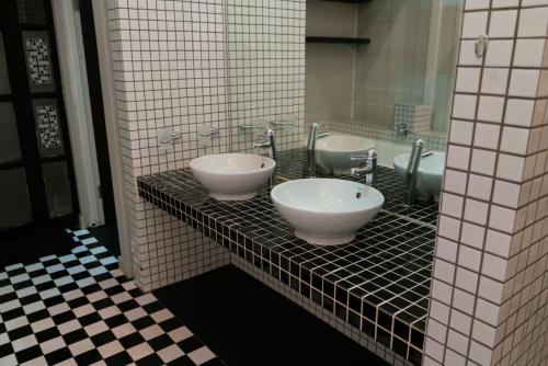 a bathroom with two sinks on a tiled counter at See You There Accommodation in Centurion