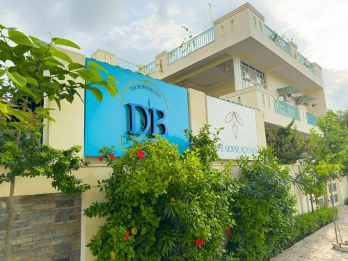a building with a sign on the side of it at Dá Bungalow - A Vacation Abode in Agra