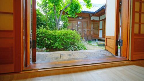 an open door to a garden outside a house at Sarangroo in Jeonju