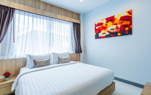 a bedroom with a large white bed with a window at "Smooth as Silk" Gorgeous 3-Bedroom Pool Villa, Just a Stone's Throw from the Beach! in Ban Khlong Haeng
