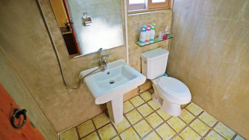 a bathroom with a sink and a toilet and a mirror at Sarangroo in Jeonju