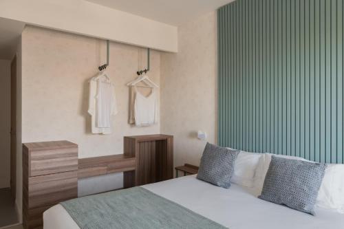 a bedroom with a bed with a green wall at Eurosalou & Spa in Salou