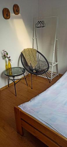 a room with a bed and a table and a chair at Zajazd Gajówka in Zwierzyniec