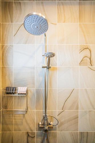a shower with a shower head in a bathroom at "Smooth as Silk" Gorgeous 3-Bedroom Pool Villa, Just a Stone's Throw from the Beach! in Ban Khlong Haeng