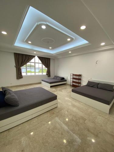 a bedroom with two beds and a ceiling at DeGarden House Bangi in Kajang
