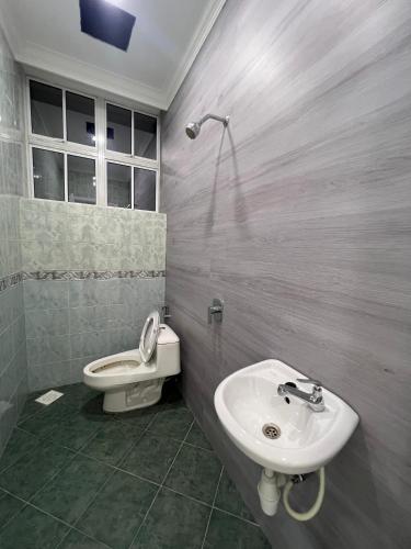 a bathroom with a sink and a toilet at DeGarden House Bangi in Kajang
