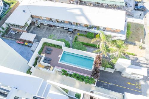an overhead view of a building with a swimming pool at Absolute Kirra by EcoTime in Gold Coast