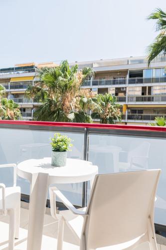 a white table and chairs on a balcony with a building at Eurosalou & Spa in Salou
