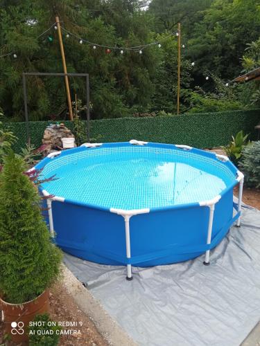 a large swimming pool with a blue top at Cottage "Sunset" in Batumi