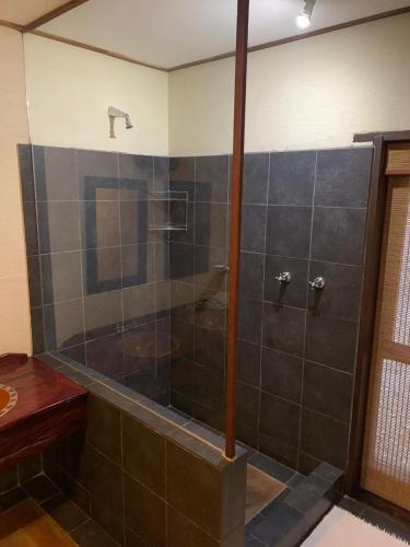a shower with a glass door in a bathroom at Leriba Lodge Unit425 in Phalaborwa