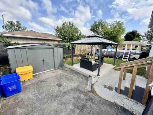 a backyard with an umbrella and a playground at Hamilton Chic Retreat - Comfy Beds - Garden - Pool in Hamilton