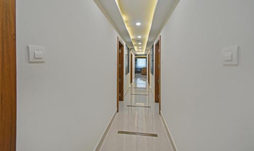a hallway with white walls and a ceiling at Itsy Hotels Deluxe Inn in Chennai