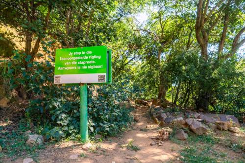 a green sign in the middle of a trail at ATKV Klein-Kariba in Bela-Bela