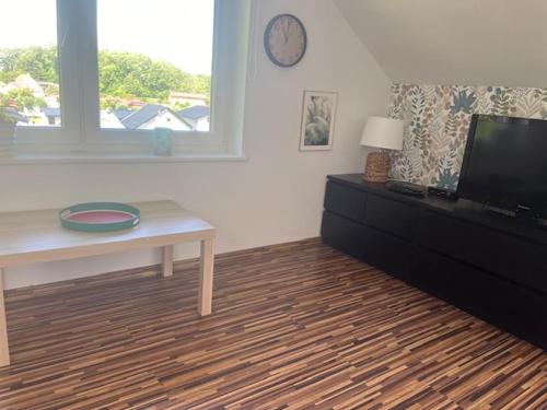 a living room with a tv and a table at Willa Sarbinowo in Sarbinowo