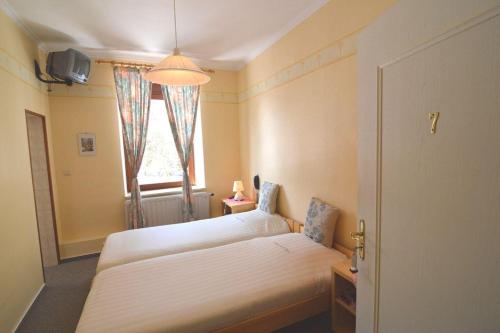 a bedroom with two beds and a window at Auberge de la Fagne in Malmedy
