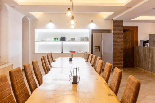 a conference room with a long table and chairs at Auberge de la Fagne in Malmedy